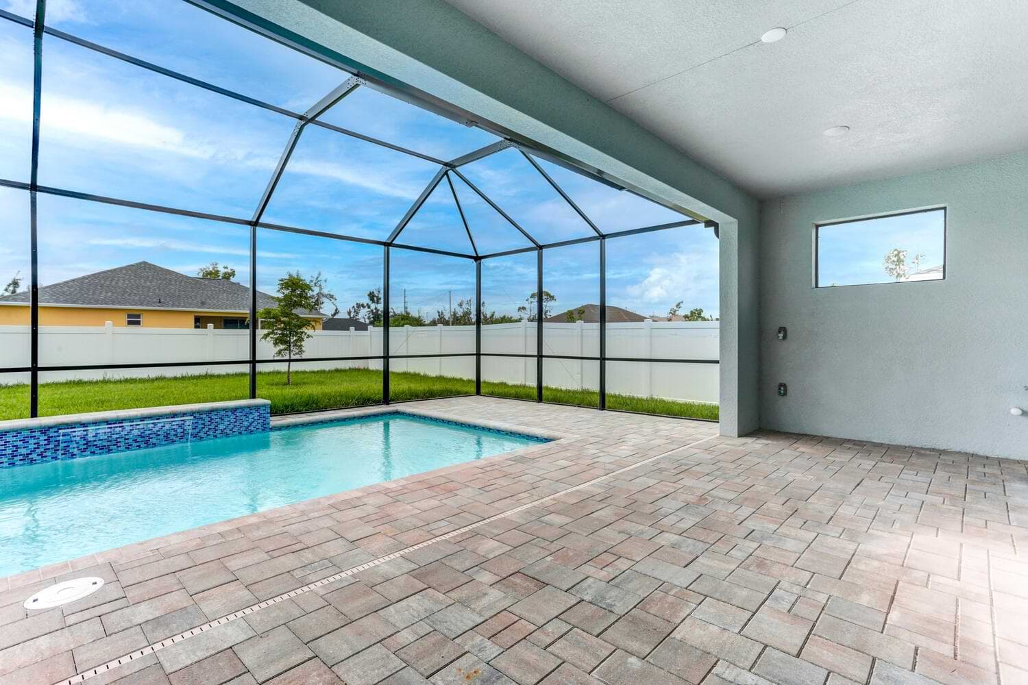 Covered lanai and screened-in pool area in the Signus model home.