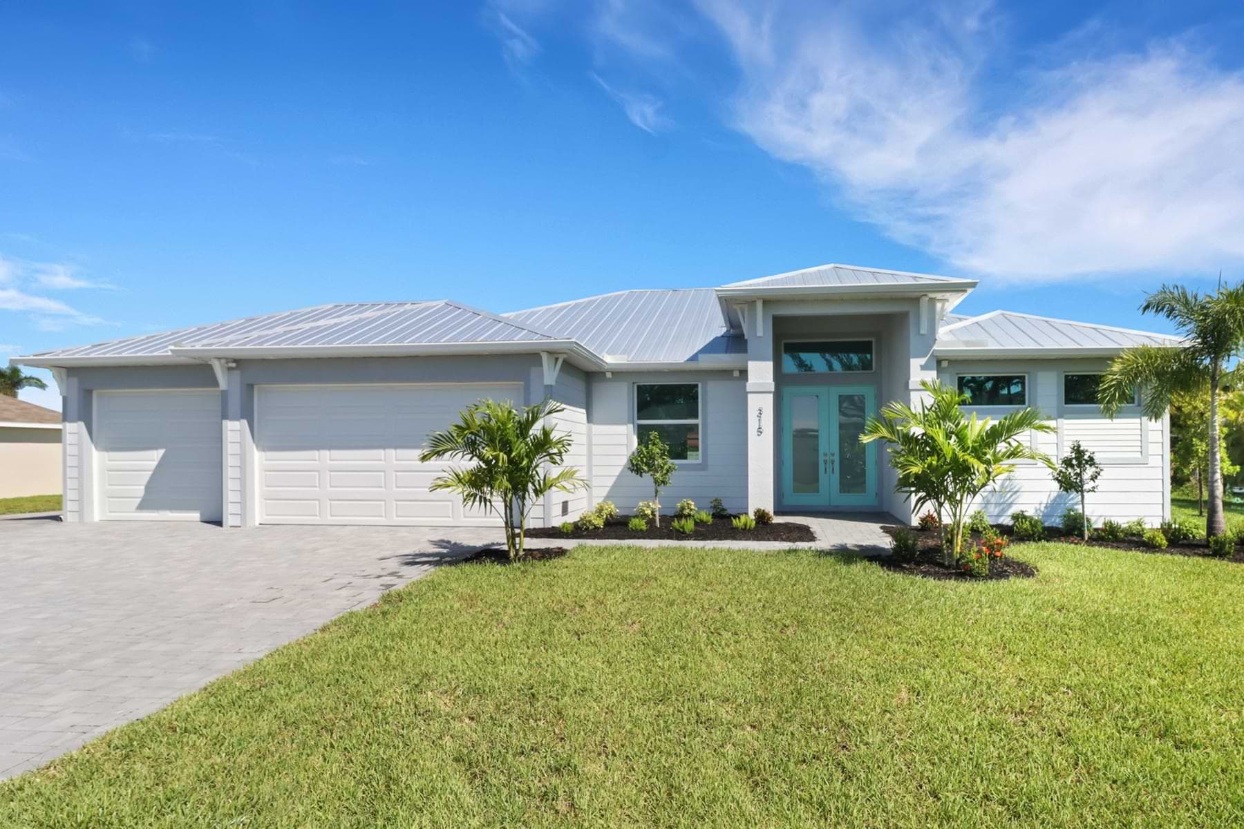 Exterior front of the Sposen Signus home with metal roof and double entry doors