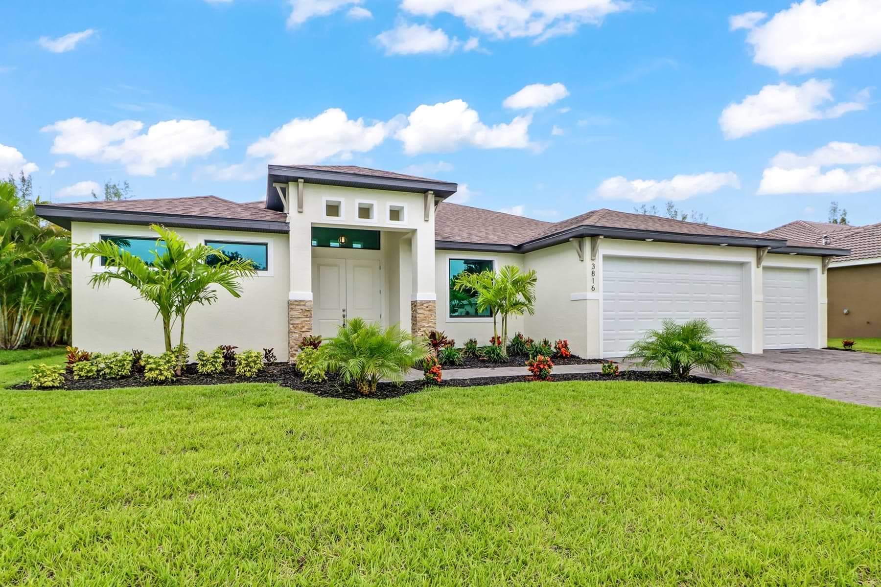 Front exterior view of the Signus model home with modern entry and lush landscaping.