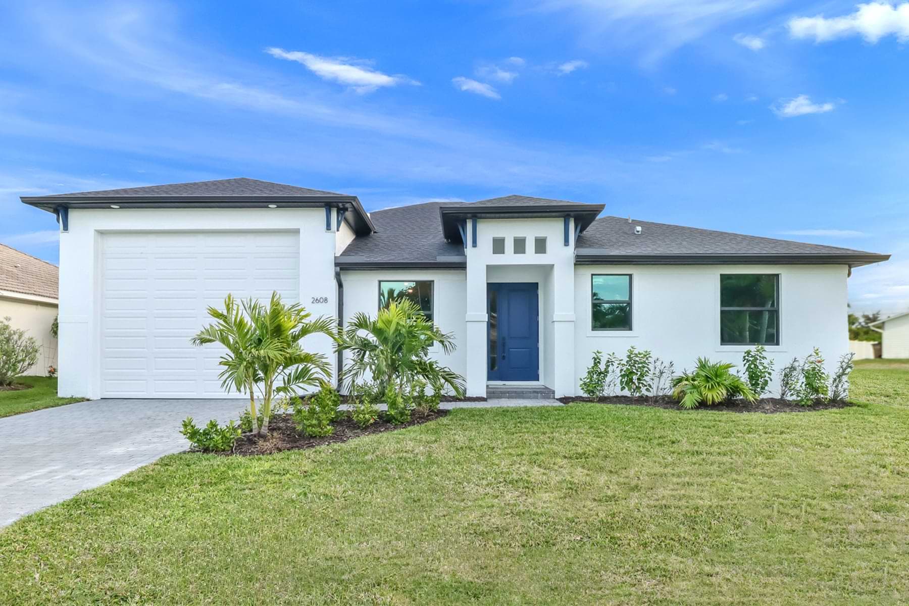 Completed Florida home with a landscaped front exterior