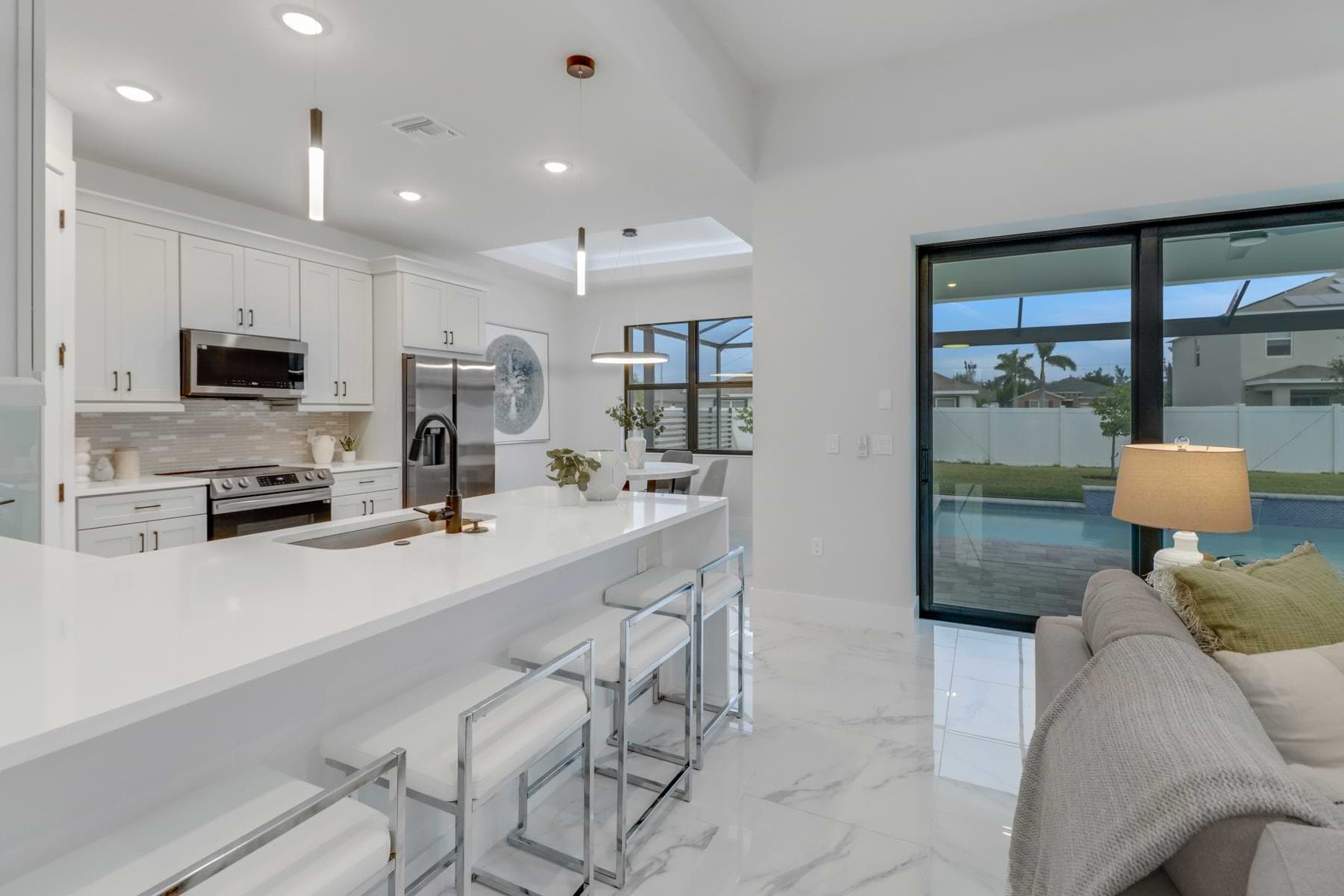 Open kitchen and living area overlooking the pool in a completed Rotonda West home.